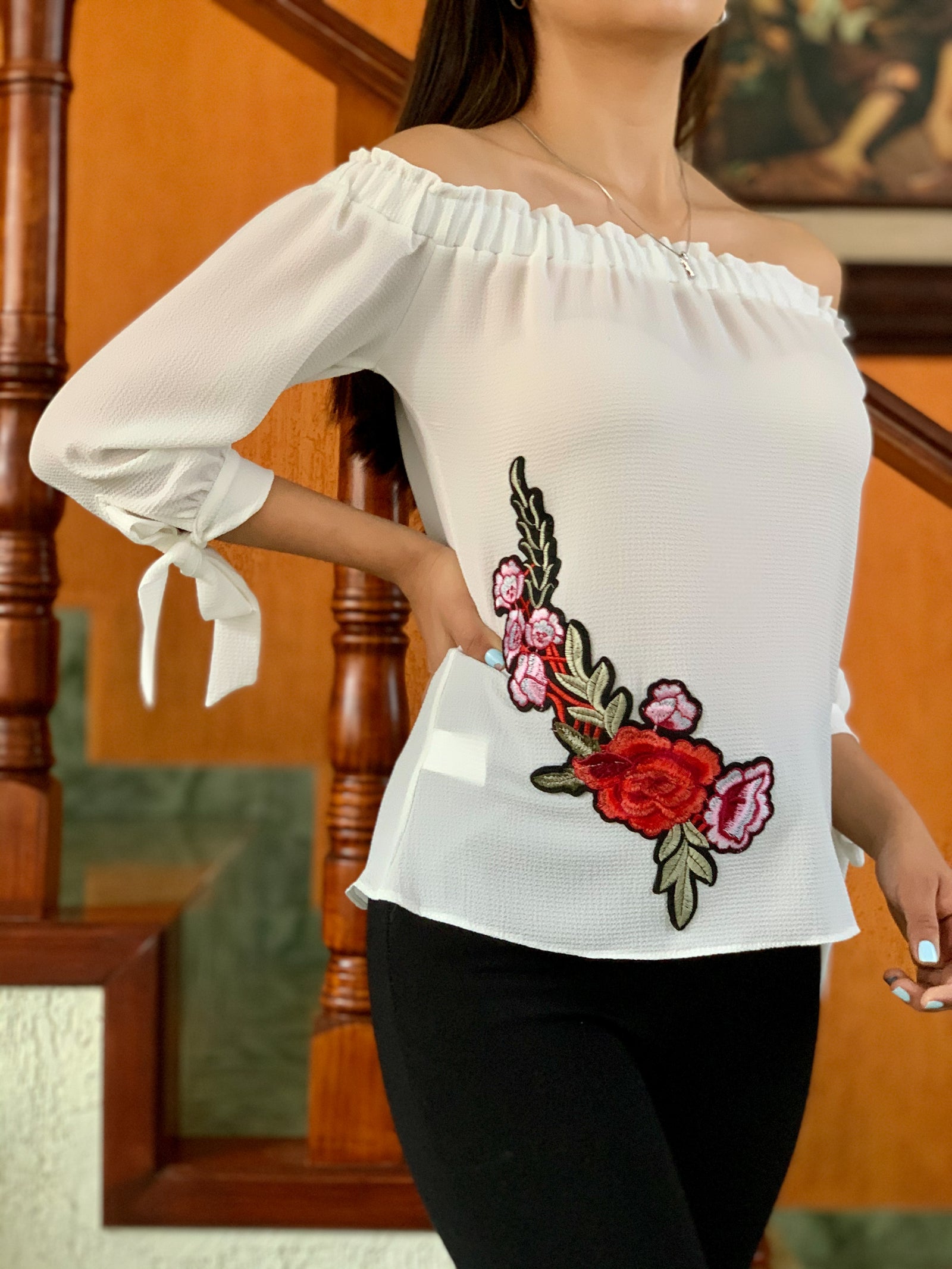 Blusa a los hombros blanca con bordado de flor y cintas en las muñecas