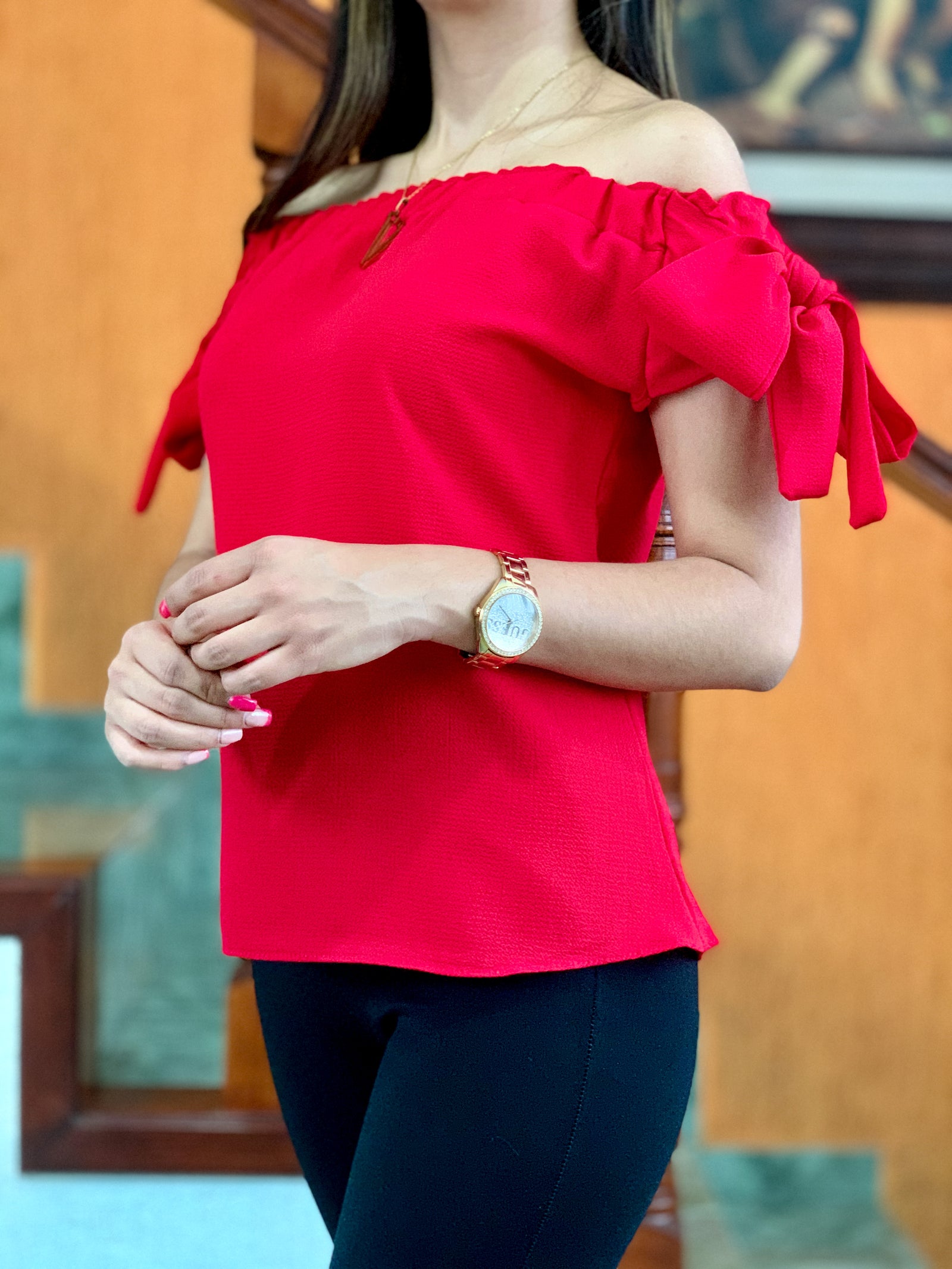 Blusa a los hombros con resorte y tiras en las mangas.